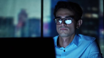 Young Executive Manager Looking at Laptop Screen at Workplace, Working in the Office