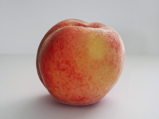 Ripe peach on a white background