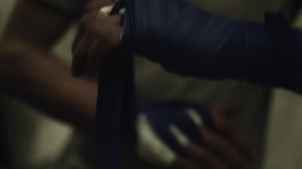 Fighter putting on hand wraps before the muay thai boxing match where he gonna win.