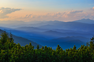 view to the mountain valley in a dense clouds at the sunset