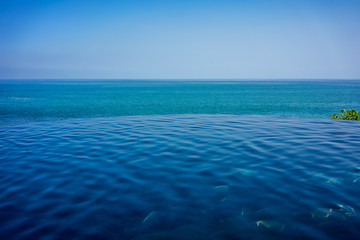 infinity pool view with blue ocean