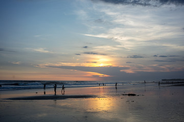 Fototapeta na wymiar people on tropical beach at sunset