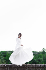 Woman in long-sleeves white dress posing