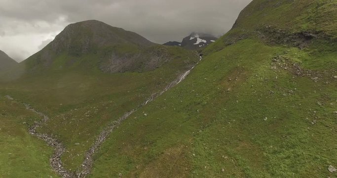 4k Drone footage of river in epic landscape in Norway Sunnmore Orsta Skorgedalen. In rainy weather in the summer.