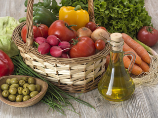 fresh vegetables with olives on a wooden table. 