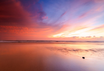 sunrise Seascape with beautiful reflection for background. soft focus due to long expose.