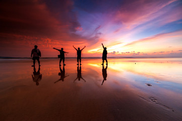 Fototapeta premium Sunrise with beautiful reflection. silhouette of unknown people appear on the image. 