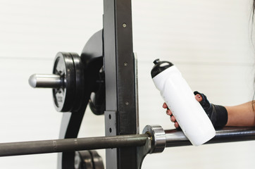 Girl holding bottle of water at gym