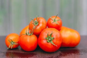 Soft tone bunch of tomatoes on the background of a wooden facade