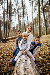 Brothers and sister kids playing in autumn park
