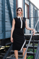 Girl posing outside in black dress