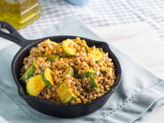 Buckwheat with zucchini and turmeric in cast iron skillet. Easy and healthy lunch for celiac gluten free diet