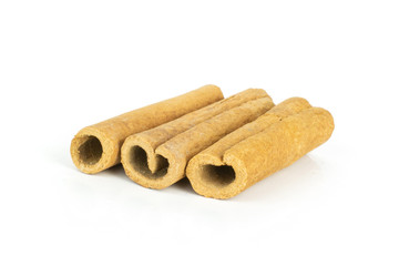 Group of three whole dry brown cinnamon stick isolated on white background