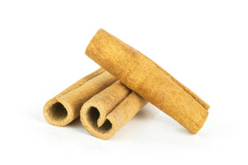 Group of three whole dry brown cinnamon stick isolated on white background
