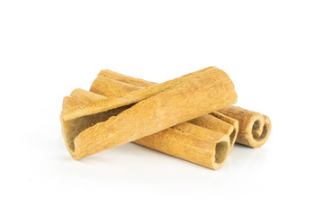 Group of four whole dry brown cinnamon stick isolated on white background
