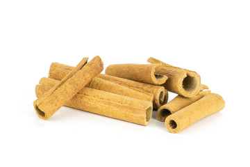 Lot of whole dry brown cinnamon stick isolated on white background