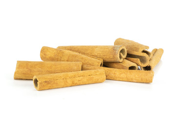 Lot of whole dry brown cinnamon stick isolated on white background