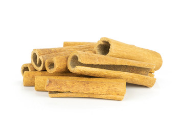 Lot of whole dry brown cinnamon stick stack isolated on white background