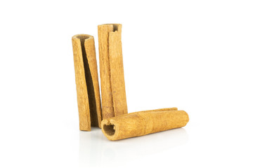 Group of three whole dry brown cinnamon stick isolated on white background