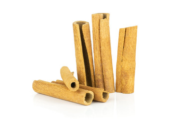 Lot of whole dry brown cinnamon stick isolated on white background