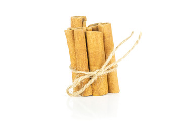 Lot of whole dry brown cinnamon stick tied by jute rope tied by jute isolated on white background