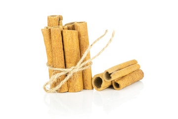 Lot of whole dry brown cinnamon stick tied by jute tied by jute isolated on white background