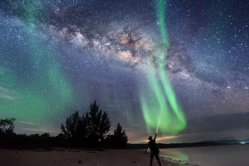 Fotobehang Milkyway with beautiful aurora Borealis. soft focus and noise due to long expose and high iso. © udoikel09