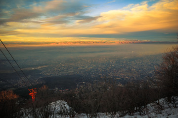 Sofia city foggy mountain golden hour view, moments before the sunset from the Kopitoto Hill,...