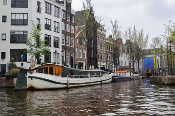 The canal of the river in Amsterdam, view from the water to the houses and the streets