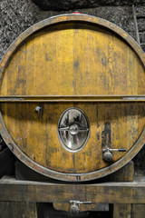 Large, wooden, oak barrel for wine with a tap for filling