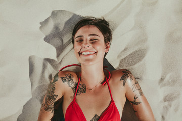 Smiling woman relaxing on beach