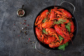 Crayfish. Red boiled crawfishes on table in rustic style, closeup. Lobster closeup. Border design. Top view. Flat lay.