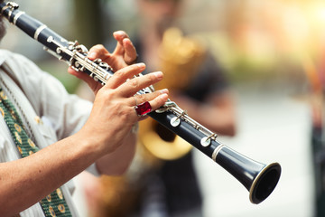 Detail of a street musician playing the clarinet - obrazy, fototapety, plakaty