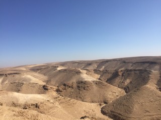 Fototapeta na wymiar Rocky hills of the Negev desert. Panoramic landscape view of the Desert rock formation in the southern Israel.