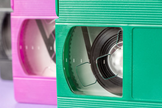 Pink, green and black VHS cassettes