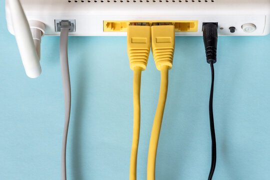 Connect An Ethernet Cable To A Wireless Router On Light Blue Pastel. Ethernet, Rj45 And Electric Cables, Connected To Router. Network Concept