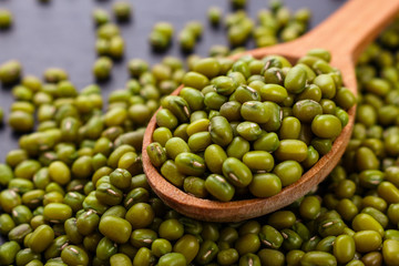 fresh Mung beans on a dark stone background