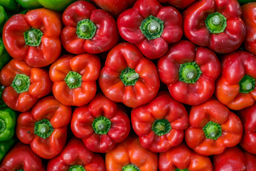 fresh red bell peppers arranged at the market