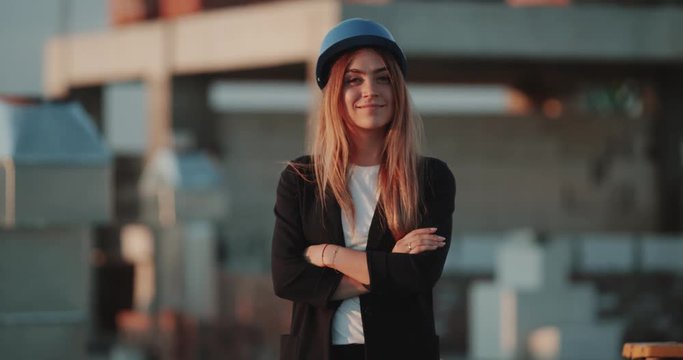 Smiling beautiful woman supervisor from construction site looking at camera.