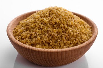 raw bulgur on a white acrylic background