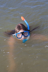 girl of thirteen in a mask for diving into the sea