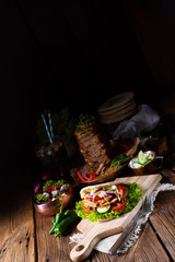 Crunchy pita with grilled gyros meat. Various vegetables and garlic sauce