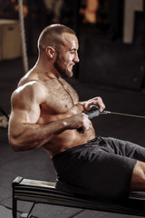 sweaty guy with clenched teeth working out in the fitness center. close up side view photo © alfa27
