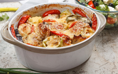 Traditional tasty rustic stew of chicken and vegetables  with Greek salad and black olives