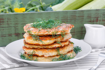 Delicious pancakes from courgettes and fresh vegetables with sour cream and dill