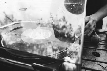 Dj playing music on a vinyl  turntable at the summer party