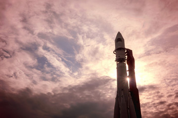 A rocket on the launch pad against the background of the dawn sky.
