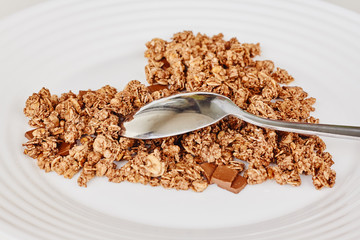 Cereal muesli breakfast and spoon on white background. Healthy eating and lifestyle concept