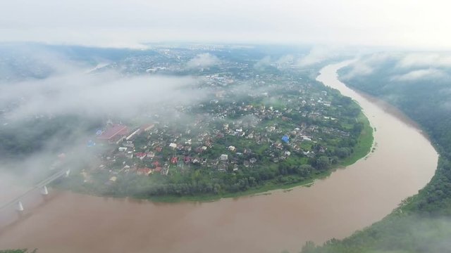 Aerial footage video of Zaleschiki, Ternopil region, Ukraine. Panoramic view at the foggy morning. Sunrise time. Flying over the river Dniester