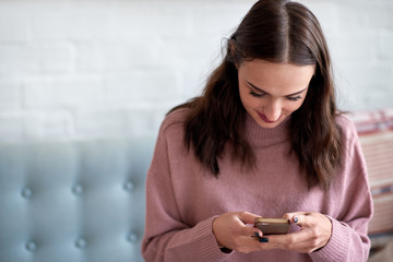 Young woman looking at mobile phone with copy space